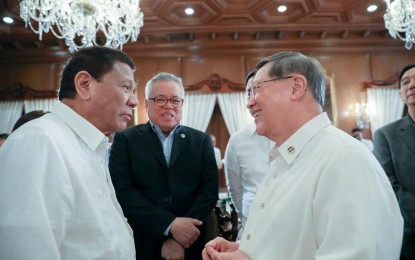 <p><strong>FUNDS FOR COVID-19</strong>. President Rodrigo Roa Duterte shares a light moment with Trade and Industry Secretary Ramon Lopez and Finance Secretary Carlos Dominguez III prior to the start of the 43rd Cabinet Meeting at the Malacañan Palace on November 6, 2019. Cabinet Secretary Karlo Nograles said Duterte has tapped his economic team to find ways to augment the funds for coronavirus disease response. <em>(Presidential photo by Ace Morandante)</em></p>