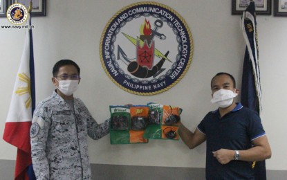 <p><strong>IMPROVING CONNECTIVITY.</strong> Naval Information and Communication Technology Center (NICTC) head, Captain Marcos Imperio (left), receives the donated information and communication equipment for troops in front line duties on Monday (April 6, 2020). The donation includes signal boosters, 10 pocket Wi-Fis and 20 cellphones with load and data, three pre-loaded Home WiFi units, and VSAT internet terminals. <em>(Photo courtesy of Naval Public Affairs Office)</em></p>