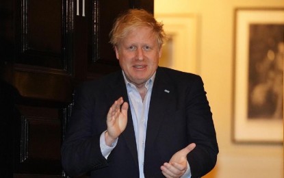 <p>File photo, taken on April 2, 2020, shows British Prime Minister Boris Johnson clapping for National Health Service staff outside 11 Downing Street in London, Britain. The Prime Minister was taken to intensive care on Monday night after his coronavirus symptoms worsened, Downing Street said. <em>(Pippa Fowles/No 10 Downing Street/Handout via Xinhua)</em></p>