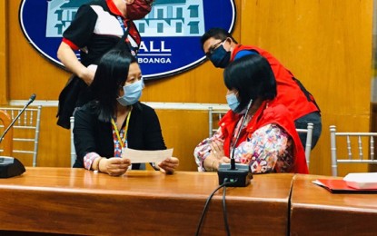 <p><strong>SOCIAL AMELIORATION.</strong> Department of Social Welfare and Development-Region 9 Director Fatima Caminan (seated, right) hands over on Tuesday (April 7, 2020) to Mayor Maria Isabelle Climaco-Salazar the amount of PHP582.59 million representing the first tranche (month of April) of the Social Amelioration Program of the national government amid the Covid-19 crisis. The beneficiaries are identified by local government units.<em> (Photo courtesy of City Hall Public Information Office)</em></p>