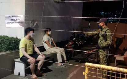 <p><strong>OUTDOOR ACTIVITIES PROHIBITED.</strong> A police officer speaks to two residents of the Bonifacio Global City (BGC) in Taguig who were apprehended for taking a leisure walk outside their homes on Wednesday (April 8, 2020). The city government has reiterated its warning to residents to refrain from doing outdoor fitness and leisure activities in compliance with the Luzon-wide enhanced community quarantine. <em>(Photo courtesy of Taguig PIO)</em></p>