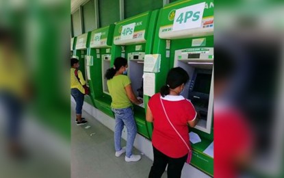 <p><strong>EMERGENCY CASH AID.</strong> Pantawid Pamilyang Pilipino Program (4Ps) members claim their emergency cash subsidy on top of their regular payout in a Landbank branch in Tacloban City. Mayor Alfred Romualdez on Thursday (April 9, 2020) signed the memorandum of agreement with the Department of Social Welfare and Development (DSWD) for the release of financial assistance to some 51, 635 families in the city displaced by the global health crisis. <em>(Photo courtesy of DSWD)</em></p>