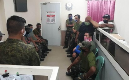 <p><span lang="EN-US">‘FAKE’ RESERVISTS. General Santos City police personnel arrest 16 individuals on Friday (April 10, 2020) for falsely claiming to be reservists of the Armed Forces of the Philippines. The suspects, who were unarmed but clad in Army fatigues, showed up and claimed that they were detailed to help secure city government personnel and the relief goods stored at the facility. <em>(Photo courtesy of the Army-led Joint Task Force GenSan)</em><br /></span></p>