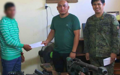 <p><strong>BIFF SURRENDERER.</strong> A member of the Bangsamoro Islamic Freedom Fighters (BIFF) receives financial assistance from former mayor Nathaniel Midtimbang (center), husband of Mayor Estephanie of Datu Anggal Midtimbang town in Maguindanao, after he and six others surrendered to the Army’s 7th Infantry Battalion (IB) based in the municipality on Friday (April 10, 2020). Lt. Col. Rommel Valencia (right), 7IB commander, witnessed the event. <em>(Photo by 7IB)</em></p>