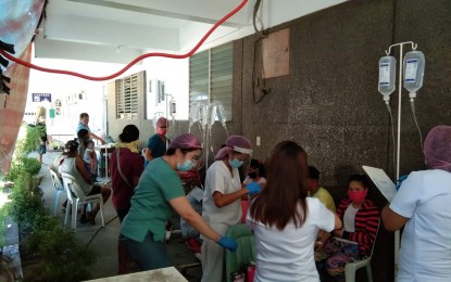 <p><strong>FOOD POISONING.</strong> Staff of the Alfredo E. Marañon Sr. Memorial District Hospital tend to patients who fell ill after eating "linugaw", a dessert soup with "kayos" or "intoxicating yam" on Friday (April 10, 2020). Some 80 affected residents from three villages were rushed to two hospitals. <em>(Photo courtesy of Sagay CDRRMO</em>)</p>