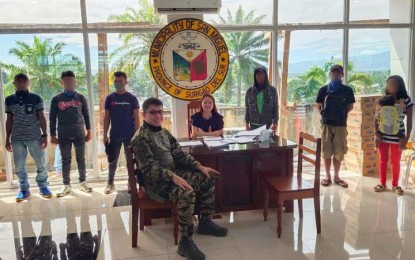 <p><strong>AID TO FORMER REBELS.</strong> San Miguel Mayor Hazel Elizalde (sitting, center) and Capt. Julius James Gabaran, (sitting, front) commander of the 7th Special Forces Company of the Army's 3rd Special Forces Battalion, lead the distribution of cash aid to 10 former rebels on Thursday (April 9) at the town hall of San Miguel. The officials call on the remaining to embrace peace and leave the communist rebel movement. <em>(Photo courtesy of the Army's 3rd Special Forces Battalion)</em></p>