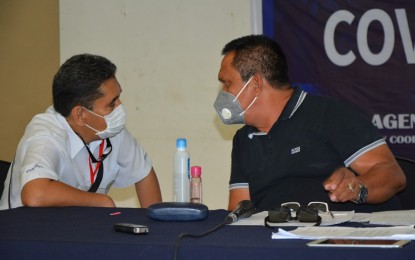 <p><strong>ECQ EXTENSION</strong>. Vice Governor Edward Mark Macias (left) and Gov. Roel Degamo in a huddle during Monday's (April 13, 2020) meeting of the Inter-Agency Task Force on Covid-19 in Dumaguete City. Following a unanimous recommendation from the IATF and other concerned sectors, Degamo announced the extension of the enhanced community quarantine (ECQ), which was originally scheduled to end April 18. <em>(Photo courtesy of Capitol PIO)</em></p>
