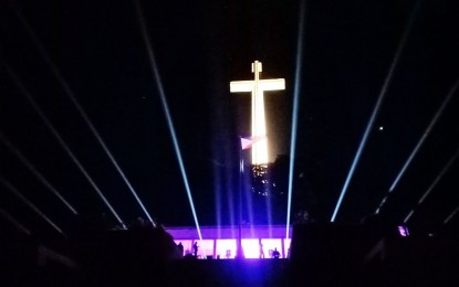 <p><strong>SALUTE OF LIGHTS.</strong> A one-hour light show was witnessed at the giant War Memorial Cross at the Mt. Samat Shrine in Pilar, Bataan on Sunday (April 12, 2020) to pay tribute to front-liners in the war against Covid-19. The Mt. Samat Flagship Tourism Enterprise Zone and Philippine Veterans Affairs Office (PVAO), in coordination with OGV Lights and Sounds, spearheaded the event dubbed as “Salute of Lights for Front-liners: We Light as One, We Heal as One." <em>(Photo courtesy of Mt. Samat Flagship Tourism Enterprise Zone)</em></p>