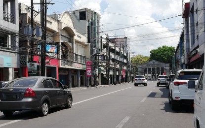 <p><strong>UNDER QUARANTINE.</strong> Private vehicles travel along Araneta Street, one of the major thoroughfares in Bacolod City, in this photo taken on April 8, 2020. Starting Wednesday (April 15, 2020), the city government will adopt a number coding scheme to reduce the number of people going out of their houses during the enhanced community quarantine to prevent the transmission of coronavirus disease.<em> (PNA photo by Nanette L. Guadalquiver)</em></p>