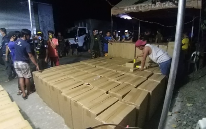 <div dir="ltr"><strong>MISDECLARATION.</strong> Law enforcers conduct an inventory of boxes filled with cigarettes intercepted at a checkpoint in Barangay Kinuskusan, Bansalan, Davao del Sur, on Monday evening. The truck occupants allegedly used food passes in sneaking out the cigarettes from Davao City. <em>(Photo courtesy of Digos Police)</em></div>