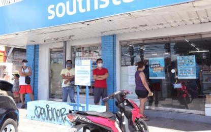 <p><strong>AVOIDING CLOSE CONTACT.</strong> Customers stand apart from each other while waiting for their turn to buy medicine from a drug store in Zabarte Subdivision along Quirino Highway in Novaliches, Quezon City. The government is strictly implementing social distancing measures to prevent the further spread of the coronavirus disease 2019. <em>(PNA file photo by Oliver Marquez)</em></p>