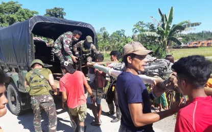 <p><strong>KILLED UNARMED.</strong> Soldiers and villagers load onto a military vehicle the dead body of Estar Behing, 34, a government militiaman who was killed by armed men believed to be members of communist New People’s Army in San Miguel, Surigao del Sur, on Tuesday (April 14, 2020). Authorities condemned the killing, as they called on human rights advocates to investigate the rebels' latest atrocity. <em>(Photo courtesy of 36th IB, Army)</em></p>