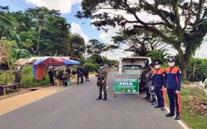 <p><strong>FIGHTING COVID-19.</strong> Local police and firemen guard a checkpoint in Opong village in Catubig, Northern Samar. The provincial government on Tuesday (April 14, 2020) approved the extension of the general community quarantine to April 30 due to the rising threat of Covid-19. <em>(Photo courtesy of Bureau of Fire Protection)</em></p>