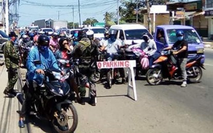 <p>KEEP PEOPLE OFF STREETS. Zamboanga City policemen inspect motorists at a checkpoint leading to the city proper on Wednesday (April 15, 2020). The city government will soon issue color-coded passes to regulate the number of people going out of their homes amid the enhanced community quarantine. <em>(Photo lifted from FB page of Bong Simbajon)</em></p>