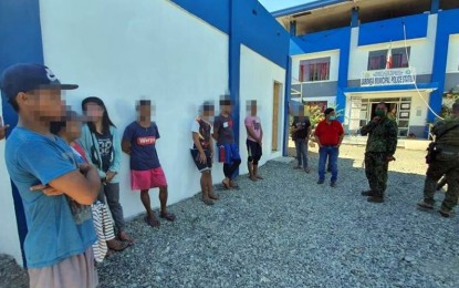 <p><strong>CAPTURED.</strong> Troopers of the Army's 29th Infantry Battalion present to the Philippine National Police in Jabonga, Agusan del Norte the six New People’s Army members who were captured following an encounter on Monday (April 13, 2020). Three minors were also rescued from the rebel movement during the encounter. <em>(Photo courtesy of 29IB)</em></p>
