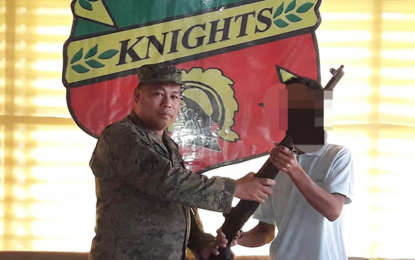 <p><strong>ASG SURRENDERER.</strong> Muhammad Batuken Balakat, who claims to be an Abu Sayyaf Group courier, hands over a Garand rifle to Lt. Col. Renante Besa, Army's 64th Infantry Battalion commander, when he surrendered Wednesday (April 15, 2020) in Barangay Tumahubong, Sumisip, Basilan province. (Photo courtesy of 64th Infantry Battalion)</p>
