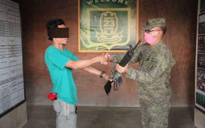 <p><strong>NO MORE HUNGER.</strong> Alias Jack, a New People’s Army combatant, surrenders to Lt. Col. Francisco Molina, Jr. (right), commander of the Army's 23rd Infantry Battalion, on April 6, 2020. Jack says hunger pushed him and six other members of the NPA's Guerrilla Front 4-A operating in Agusan del Norte to return to the fold of the law. <em>(Photo courtesy of 23IB)</em></p>