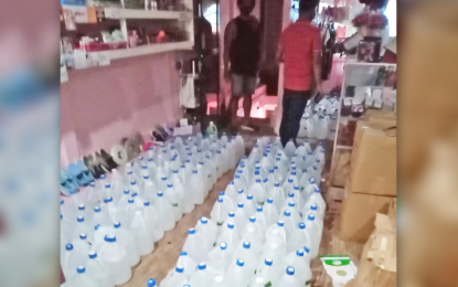 <p><strong>OVERPRICED.</strong> Authorities seize hundreds of gallons of alcohol and disinfectant from a local retailer and two other persons during an entrapment in Barangay. Poblacion, Iligan City, on April 21, 2020. Police accused the suspect of selling online overpriced alcohol and disinfectants, in violation of the government's price freeze order arising from the 2019 coronavirus disease pandemic. <em>(Photo courtesy of DTI-Lanao del Norte)</em></p>