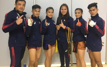 <p><strong>SUPPLEMENTAL ALLOWANCE</strong>. The Muay Thai Association of the Philippines has released on Tuesday a PHP5,000 supplemental allowance for each of its athletes and coaches, said muay Thai waikru-taksa gold medalist Jearome Calica (right) seen here with the national team of the event under coach Billy Alumno (left). Also in photo is Rusha Bayacsan (2nd right). <em>(Photo from the Facebook page of Jearome Calica)</em></p>