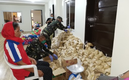 <p><strong>RESERVISTS TO THE RESCUE.</strong> Army reservists assist in the preparation of relief goods for residents of Kapatagan in Lanao del Sur on Thursday (April 23, 2020). Some 235 reservists have been enlisted to help in the local government's relief effort and implementation of the quarantine measures to contain the 2019 coronavirus disease. <em>(PNA photo by Divina M. Suson)</em></p>