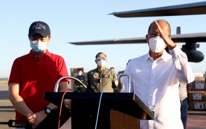 <p><strong>GRATITUDE.</strong> Defense Secretary Delfin Lorenzana (right) expresses gratitude to Senator Sherwin Gatchalian and his family for donating PPE sets and medical supplies in a turnover ceremony at the Villamor Airbase on Sunday (April 26, 2020). Aside from PPE sets, the Gatchalian family's donation consists of essential medical supplies such as surgical face masks, face shields, goggles, gloves, and KN-95 face masks. <em>(Photo courtesy of DND Public Affairs Service)</em></p>