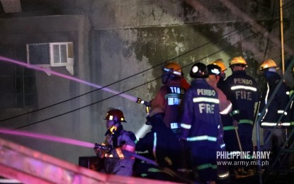 <p><strong>FORT BONIFACIO FIRE.</strong> Philippine Army troops and firefighters extinguish the fire that razed the Finance Center Philippine Army (FCPA) building in Fort Bonifacio, Taguig City on Monday (April 27, 2020). Initial investigation showed the fire started at the Governance and Strategy Management Office (GSMO) located at FCPA building at around 8:45 p.m. and was declared fire out at 10:03 p.m. <em>(Photo courtesy of Army Chief Public Affairs Office)</em></p>