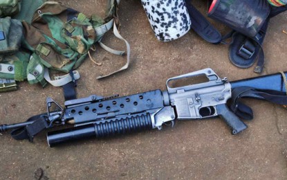 <p><strong>RECOVERED FIREARM</strong>. Government troops recover an M-16 Armalite rifle with attached M-203 grenade launcher following a firefight in Barangay Tumatangis, Indanan, Sulu on April 28, 2020. The firefight resulted in the death of an Abu Sayyaf Group bandit and the wounding of a government soldier. <em>(Photo courtesy of Joint Task Force Sulu)</em></p>