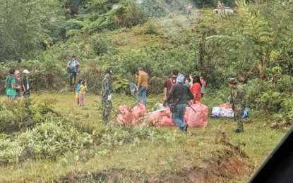 <p><strong>AID DELIVERY.</strong> Air Force troops deliver food packs to residents of Barangays Baden and Tacadang in Kibungan, Benguet on Wednesday (April 29, 2020). The Air Force deployed a UH-1D helicopter to help ferry the food packs for families in the areas which are not accessible to land transport. <em>(Photo courtesy of Air Force Public Affairs Office)</em></p>