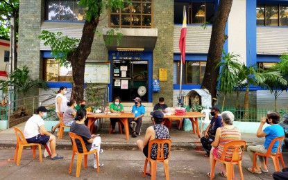 <p><strong>COVID-19 RESPONSE.</strong> Officials and residents of Barangay N.S. Amoranto maintain social distancing while the walk-in application for the DSWD's SAP is ongoing in front of the barangay hall. The village is also using an Integrated Barangay Information System (IBIS), to ensure equal distribution of aid to residents amid the coronavirus disease 2019 (Covid-19) crisis. <em>(Contributed photo from Barangay N.S. Amoranto)</em></p>