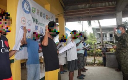 <p><strong>BACK TO THE FOLD OF LAW.</strong> Lt. Col. Reandrew P. Rubio (right), acting commander of the 91st Infantry "Sinagtala" Battalion, leads the nine members of the Communist Front Organization (CFO) as they take their oath of allegiance to the government in Barangay Diaat, Maria Aurora, Aurora on Wednesday (April 29, 2020). The rebels admitted that they were victims of deception of the terrorist group and vowed to support the programs and initiatives of the government for peace and development. <em>(Photo courtesy of the 91st Infantry Battalion)</em></p>