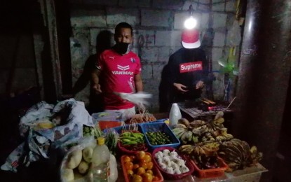 <p><strong>'NEW OPPORTUNITY’.</strong> Samad Maulana (left) sells fruits and vegetables in Barangay Culiat, Quezon City on Wednesday (April 29, 2020). Maulana put up a barbecue business and vegetable retail from the cash assistance he received from the government. (PNA photo by Lade Kabagani)</p>
<p> </p>