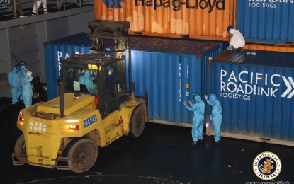 <p><strong>PPE SETS FROM CHINA.</strong> Chinese contractors haul container vans where PPE sets procured by the Philippine government will be loaded at the Zhangzhou Harbor, Port of Xiamen in China on Thursday (April 30, 2020). The BRP Bacolod City arrived in Xiamen on April 25 to pick up the cargoes of PPE sets to be used by front-liners in the battle against coronavirus disease 2019. <em>(Photo courtesy of Naval Public Affairs Office)</em></p>