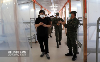 <p><strong>PATIENT CARE CENTER.</strong> Philippine Army officials and Architect William Ti Jr. of WTA Architecture & Design Studio (left) take a look at one of three new emergency quarantine facilities (EQFs) in Fort Bonifacio, Taguig City on Monday (May 4, 2020). The Army will use the EQFs in augmenting its efforts to contain the coronavirus disease 2019 (Covid-19) pandemic. <em>(Photo courtesy of Army Chief Public Affairs Office)</em></p>