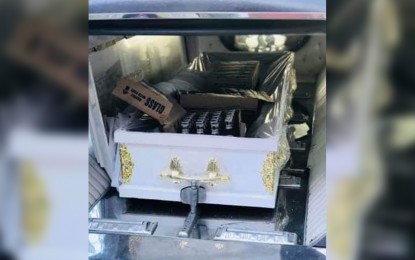 <p><strong>LIQUOR SMUGGLING</strong>. Authorities intercept a hearse loaded with boxes of liquor hidden inside a casket on Tuesday (May 5, 2020) in Binmaley, Pangasinan. The modus was discovered when the driver evaded a quarantine checkpoint. <em>(Photo courtesy of Lt. Col. Brendon Palisoc)</em></p>