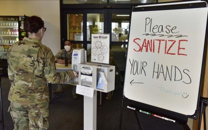 <p>An Airman assigned to the 354th Medical Group sanitizes her hands on Eielson Air Force Base, Alaska, March 20, 2020. The 354th MDG has taken extra precautions to help stop the spread of the novel coronavirus including implementing a checkpoint at the front entrance of the clinic. <em>(U.S. Air Force photo by Senior Airman Beaux Hebert)</em></p>