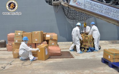 <p><strong>FACE MASK DONATION.</strong> Philippine Navy troops in personal protective equipment load boxes of donated face masks into the BRP Davao del Sur and BRP Ramon Alcaraz at Port Cochin in India on Wednesday (May 6, 2020). The two Navy ships made a brief stop in India to pick up the donations after finishing a repatriation mission for distressed FIlipino workers in Oman earlier in April. <em>(Photo courtesy of Naval Public Affairs Office)</em></p>