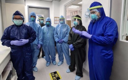 <p><strong>COVID-19 TEST TRAINING.</strong> Some members of a team of 10 medical personnel from the Department of Health (DOH)-Eastern Visayas wear personal protective equipment (PPE) while undergoing training on coronavirus disease 2019 (Covid-19) testing at the Vicente Sotto Memorial Medical Center Sub-National Laboratory in Cebu City on Friday (May 8, 2020). The training involved a pathologist and nine medical technologists from DOH-8 to prepare for Research Institute for Tropical Medicine (RITM)-accreditation of Eastern Visayas Regional Medical Center molecular laboratory setup to test for Covid-19.<em> (Photo courtesy of OPAV)</em></p>
