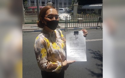 <p>Mrs. Relisa Lucena shows a copy of the  Writs of Habeas Corpus and Amparo petition filed before the Supreme Court on Friday (May 8) for her daughter, Alicia Jasper Lucena, who was allegedly recruited by alleged communist-linked groups. (<em>PNA photo by Marita Moaje</em>)</p>