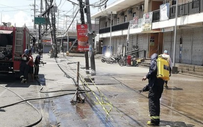 <p><strong>MARKET-WIDE DISINFECTION.</strong> Personnel of the Talisay City Fire Station conduct decontamination activities at the Tabunok Public Market on Sunday (May 10, 2020) as part of the city government's measures to fight the coronavirus disease 2019 (Covid-19). Mayor Gerald Anthony Gullas issued an executive order closing every Sunday the Tabunok Public Market, one of the largest local government-run markets in southern Cebu, and assigning market days per village, as the latest measure in battling Covid-19.<em> (Photo courtesy of Talisay City Fire Station)</em></p>