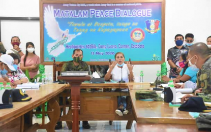 <p><strong>PEACE MEDIATORS.</strong> North Cotabato Governor Nancy Catamco (right), stresses a point during a peace dialogue between warring Moro families – belonging to local factions of the Moro National Liberation Front and the Moro Islamic Liberation Front - in Carmen, North Cotabato on Wednesday (May 13, 2020), as Brig. Gen. Roberto Capulong (left), Army’s 602nd Army brigade commander, listens. Both Catamco and Capulong initiated the dialogue to end the decades-old conflict that claimed lives from both sides and affected hundreds of civilian families. <em>(Photo courtesy of North Cotabato PIO) </em></p>