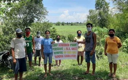 <p><strong>INSTALLED.</strong> Some of the 57 agrarian reform beneficiaries are installed on a 32.39-hectare property in Barangay Abuanan in Bago City. During the ceremony, personnel of the Department of Agrarian Reform Negros Occidental II-South divided the beneficiaries into five batches to avoid a large gathering, the office reported on Thursday (May 15, 2020). <em>(Photo courtesy of DAR Negros Occidental II-South)</em></p>