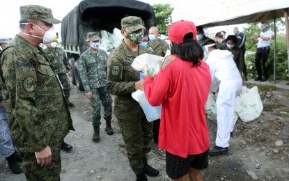 <p><strong>RELIEF DRIVE.</strong> AFP chief-of-staff Gen. Felimon Santos Jr. (center) leads the distribution of relief packs to residents of Purok 1 and 2 in Barangay New Lower Bicutan, Taguig City on May 14, 2020. The AFP received a 90-percent satisfaction rating among government agencies surveyed for their coronavirus disease 2019 (Covid-19) response based on a non-commissioned survey conducted by RLR Research and Analysis Inc. <em>(File photo courtesy of AFP Public Affairs Office)</em></p>