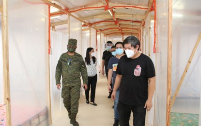 <p><strong>PATIENT CARE CENTER.</strong> AFP Chief Engineer, Brig. Gen. William Ilagan (left) and Architect William Ti Jr. of WTA Architecture + Design Studio (right) lead the inspection and turnover of an emergency quarantine facility (EQF) to the Caloocan City government on Thursday (May 14, 2020). The 16-bed EQF is located at the Caloocan Sports Complex in Barangay Bagumbong.<em> (Photo courtesy of AFP Public Affairs Office)</em></p>