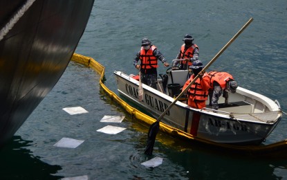<p><strong> OIL SPILL.</strong> Personnel from the Phil. Coast Guard (PCG) in Northern Mindanao clean up a portion of the seaport in Barangay Macabalan, Cagayan de Oro City on Friday (May 15, 2020) where an oil spill occurred. PCG officials said more than 200 liters of oil have already been retrieved from the sea since May 14 when the spill was reported. <em>(PNA photo by Jigger J. Jerusalem)</em></p>