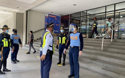 <p><strong>RESTRICTIONS STAY.</strong> Lt. Gen. Guillermo Eleazar, JTF CV Shield commander (center), talks to a security guard during his inspection at a mall along Edsa North Avenue in Quezon City on Monday (May 18, 2020). The Department of the Interior and Local Government has ordered the police and LGUs to ensure malls' compliance with quarantine protocols and safe physical distancing measures after they were allowed to reopen under a modified enhanced community quarantine. <em>(Photo courtesy of JTF CV Shield)</em></p>