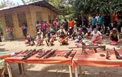 <p><strong>NPA SURRENDERERS.</strong> Former communist New People’s Army rebels pose with their surrendered firearms and explosives after yielding to the police and the military on May 15, 2020 in Banga town, South Cotabato province. The 21 returnees, who were presented to local officials and the media on Monday (May 18, 2020) will be enlisted into the government’s Enhanced Comprehensive Local Integration Program. <em>(Photo courtesy of Police Regional Office-12)</em></p>