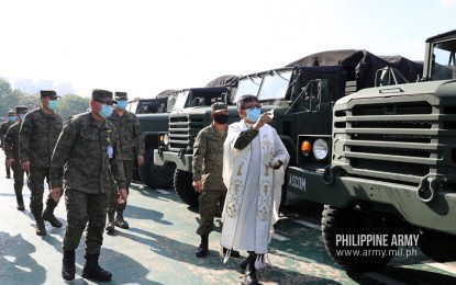 <p><strong>NEW ARMY TRUCKS.</strong> Army officials lead the blessing of 50 new troop carrier trucks in Fort Bonifacio, Taguig City on Tuesday (May 19, 2020). These trucks will augment the Army's existing mobility assets and will be used in Covid-19 operations in the country.<em> (Photo courtesy of the Army Chief Public Affairs Office)</em></p>