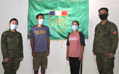<p><strong>SURRENDER.</strong> Lt. Col. Erwin Cariño (right), commander of 15th Infantry Battalion, and 2nd Lt. Weann Sandag (left), civil-military operations officer, with former rebels Hermosilla “Aya” Villamor (2nd from right) and Teody “Koko” Manorte, who surrendered to the unit in Cauayan, Negros Occidental last Thursday (May 14, 2020). The 15IB is assisting the two in the processing of documentary requirements for their enrollment in the government’s Enhanced-Comprehensive Local Integration Program.<em> (Photo courtesy of 15th Infantry Battalion, Philippine Army)</em></p>