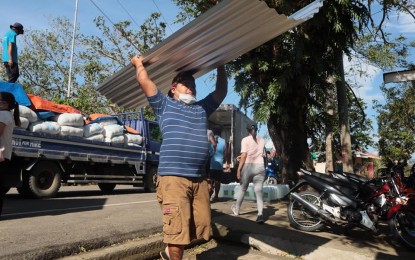 <p><strong>RECONSTRUCTION.</strong> A worker carries a corrugated sheet donated by An Waray Party-list for typhoon victims in Northern Samar on Tuesday (May 19, 2020). The An Waray Party-list has turned over 2,000 roofing materials to help families in Northern and Eastern Samar rebuild their houses destroyed by Typhoon Ambo. <em>(Photo courtesy of Northern Samar provincial government)</em><strong> </strong></p>