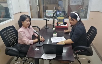 <p><strong>RADIO INFO DRIVE.</strong> Commission on Population and Development (PopCom) 8 (Eastern Visayas) Director Elnora Pulma (left) answers questions from a radio anchor in one of their programmings in Tacloban City. PopCom launched on Wednesday (May 20, 2020) a radio program and a helpline to help ensure that couples and individuals are well-informed about family planning services and adolescent health and development amid movement restrictions. <em>(PNA photo by Lizbeth Ann Abella)</em></p>